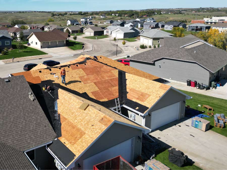 roof-repairs Dakota Storm Roofing contractor performing expert roof deck repair and storm damage restoration on a residential home.