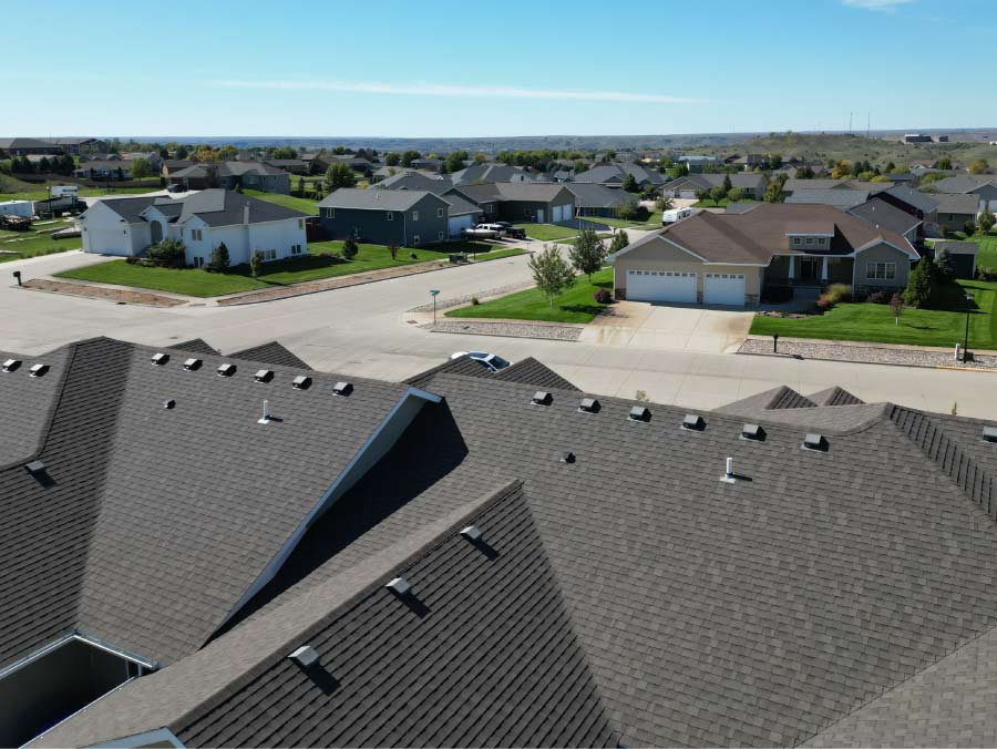 roofing-top Professional aerial view of a residential roofing installation featuring dark asphalt shingles in Pierre, SD by Dakota Storm Roofing.