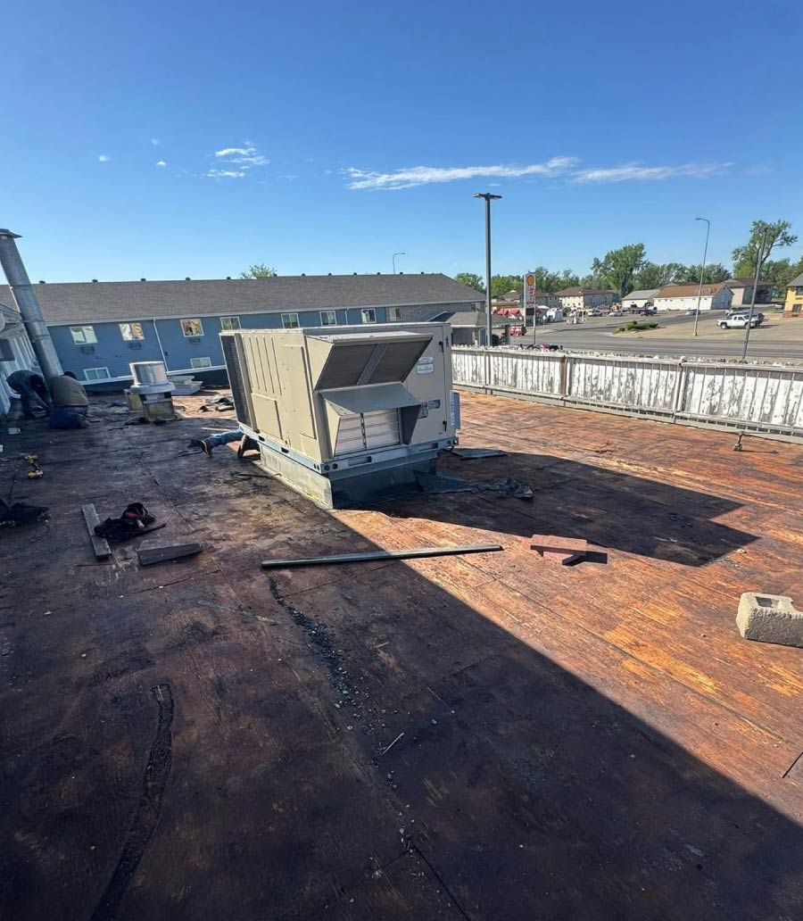 OLD-ROOF A commercial flat roof surface in Central South Dakota undergoing professional removal and restoration by the Dakota Storm Roofing team.