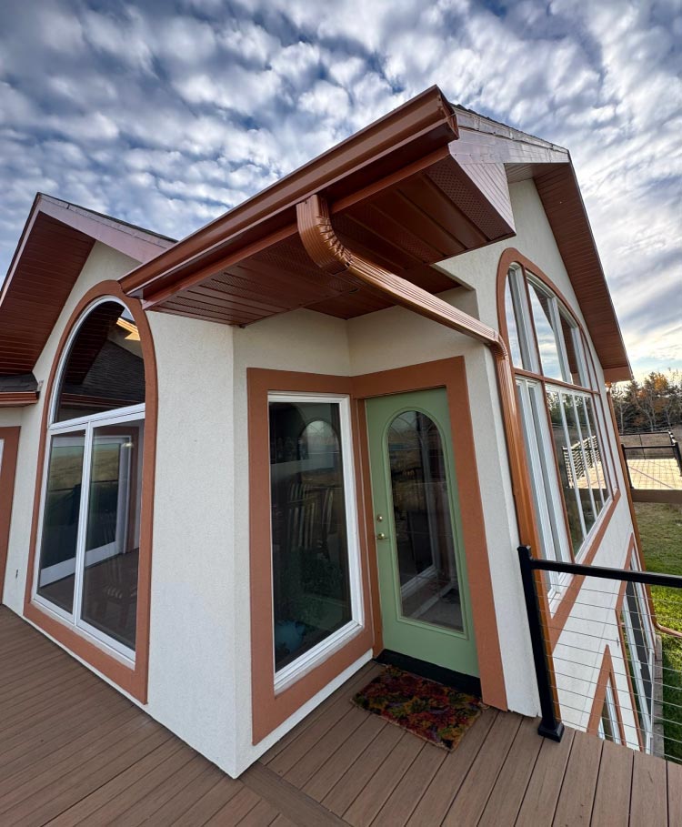 brown-gutters Finished exterior view featuring custom-fitted brown gutters and matching fascia trim, providing a cohesive and durable drainage solution for a home