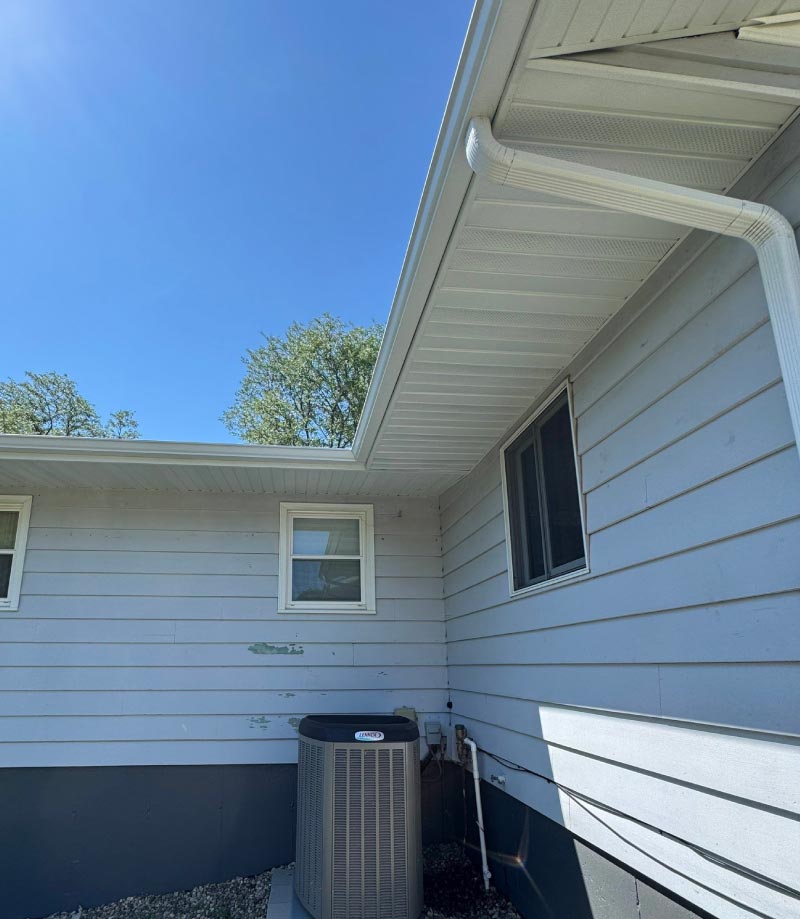 huford-after Modern, freshly installed white vinyl soffit and matching fascia trim on a residential property, showcasing a clean, finished look