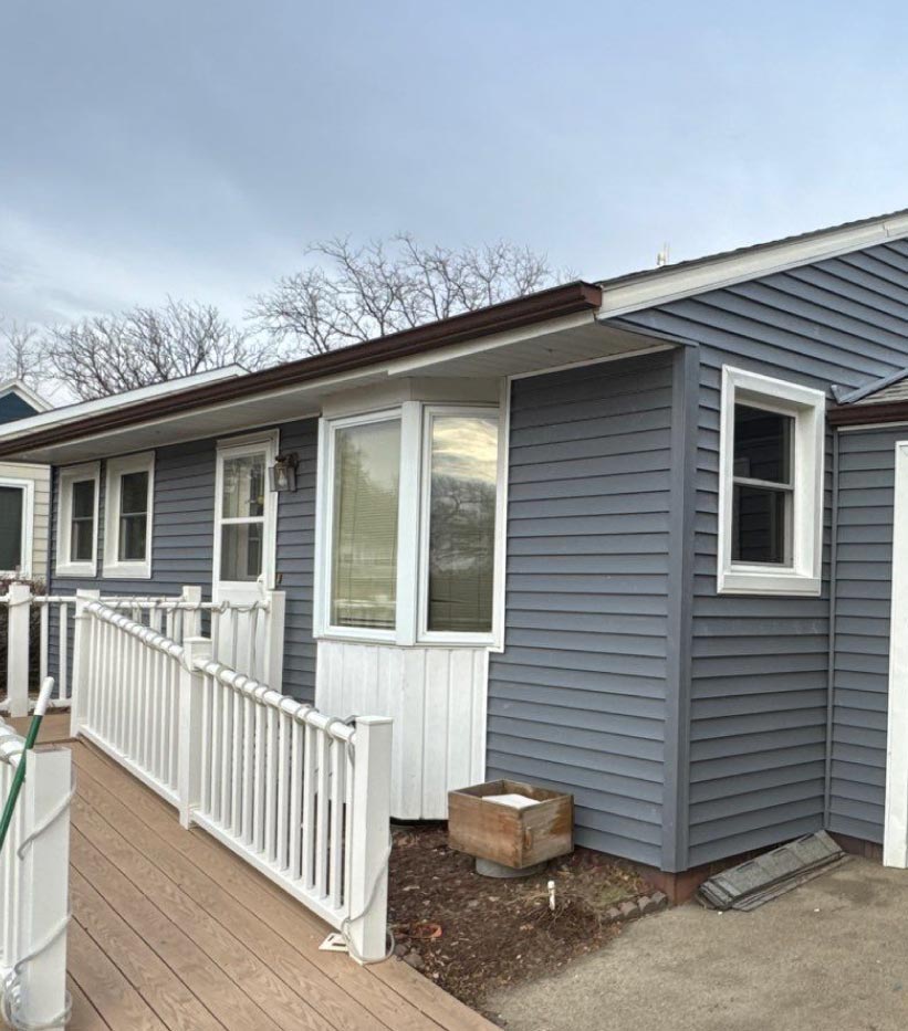 new-siding-and-windows A fully renovated home exterior featuring modern siding and updated windows, significantly improving the property's aesthetic