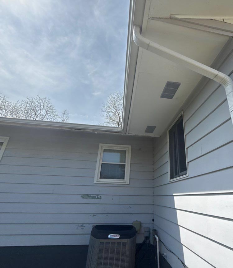 old-fascia Weathered wooden fascia and outdated soffit panels on a residential home exterior requiring professional replacement by Dakota Storm Roofing LLC