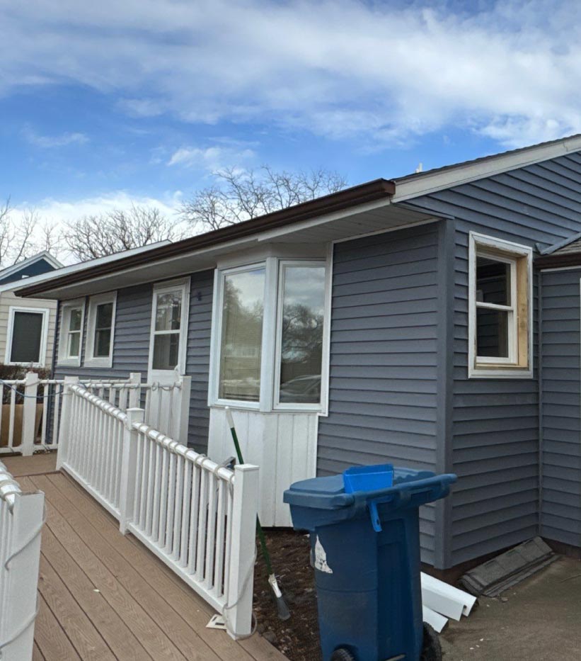 old-siding-windows View of a residential exterior in need of renovation, featuring outdated siding and window systems